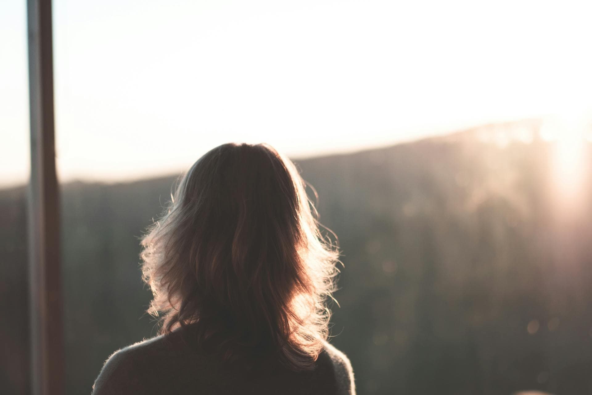 woman looking from window